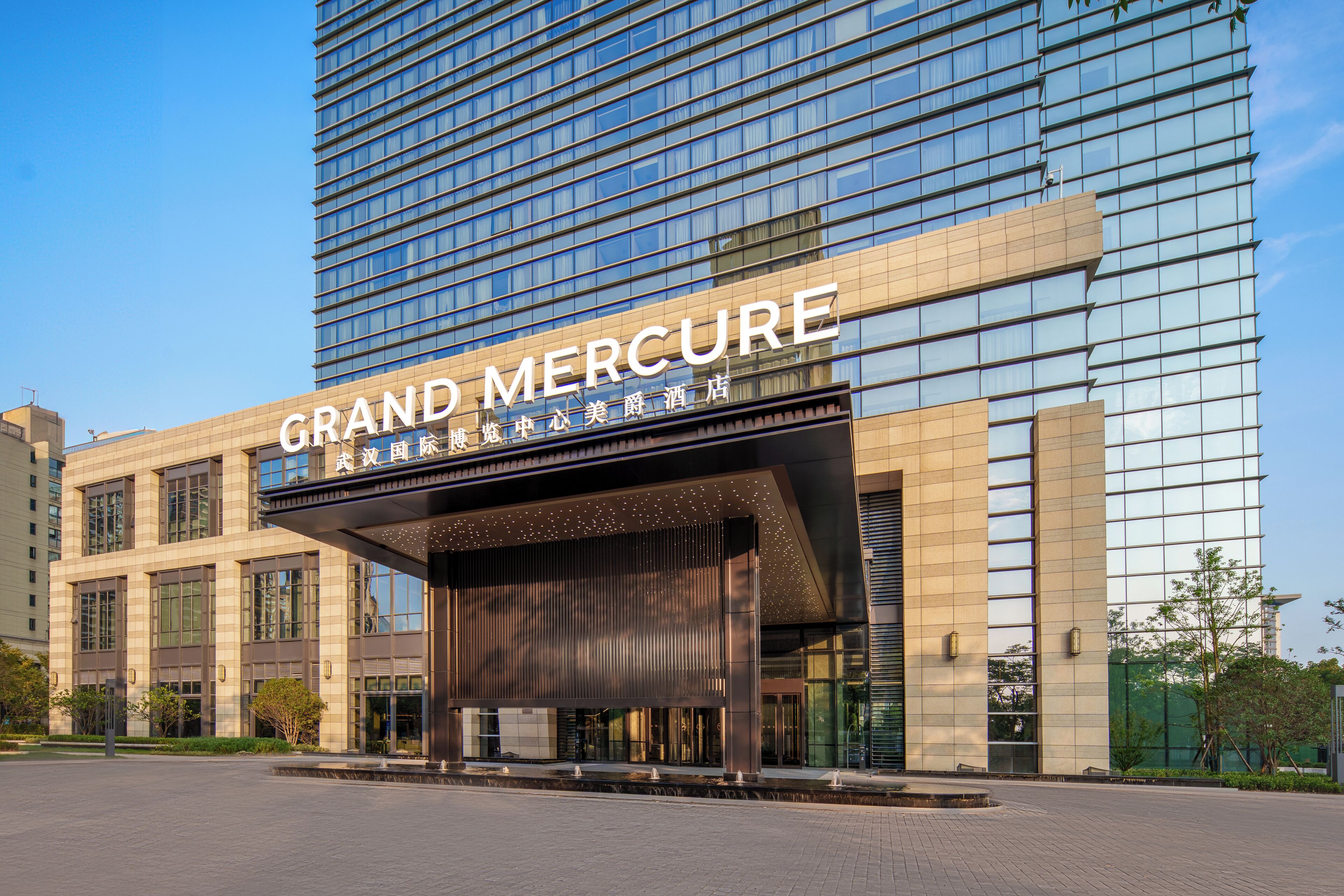 A modern hotel with a prominent sign reading "GRAND MERCURE".