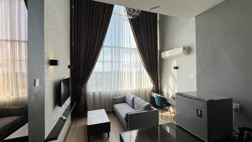 Family Apartment, City View | Living area | Flat-screen TV