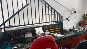 A workspace with a desk, computer, and various office supplies.