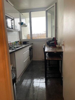 Enjoy cooking in this well-equipped kitchen with a sink, stove, and dishwasher.