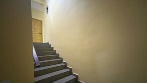 A staircase with a handrail leading to a door at the top. - Hotel O RAHMAH SOJOURN CENTRE (Johor Bahru)