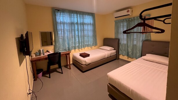 A hotel room with two beds, a desk, a chair, a TV, and an air conditioning unit. - Hotel O RAHMAH SOJOURN CENTRE (Johor Bahru)