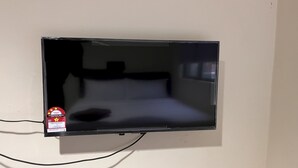 A television mounted on a wall in a room.
