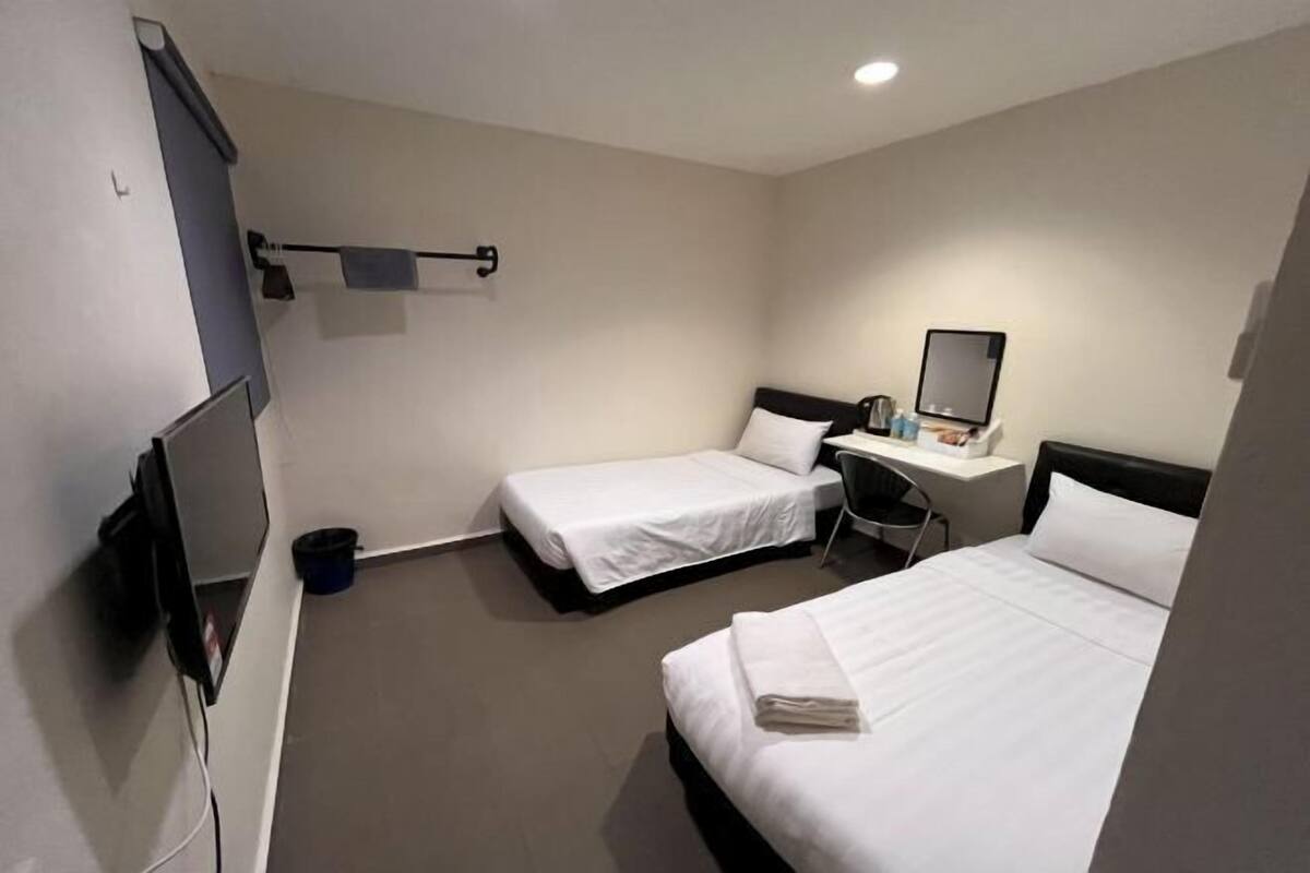 Desk, laptop workspace, bed sheets