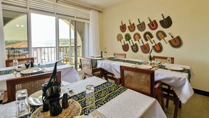 A dining area with tables set for two, featuring traditional tablecloths and woven placemats. - Hotel 256 Kampala (Kampala)
