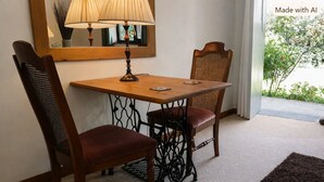 A dining area with a table and chairs, a lamp, and a view of greenery outside. - Langford Apartments and Rooms (Bristol)
