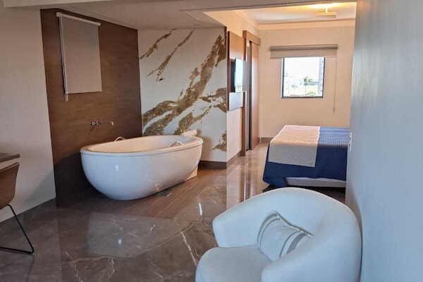 Deluxe Suite, City View | Living area | TV