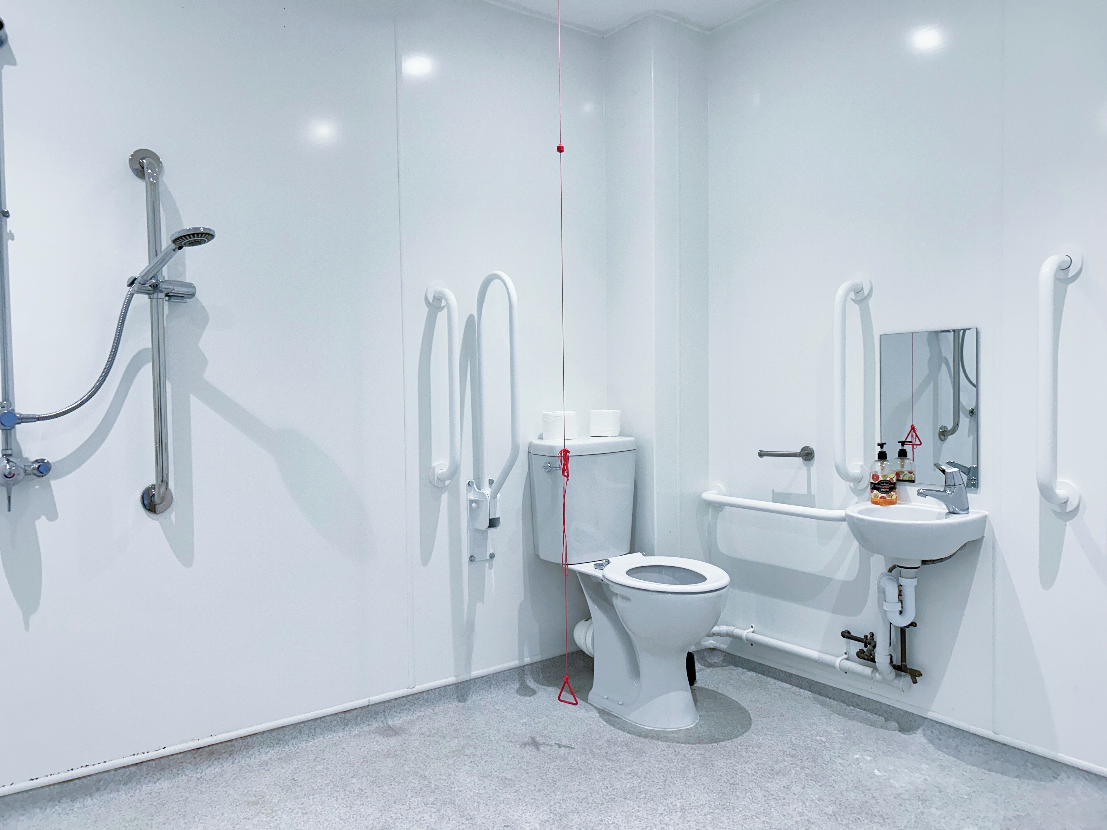 A modern bathroom with a toilet, bidet, and sink.