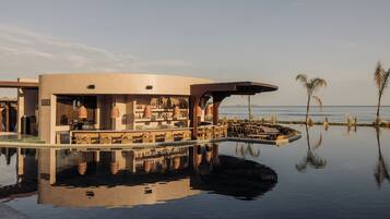 A bar area with a pool reflecting the surroundings.