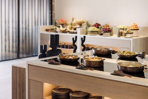 Montaje de bufé con diversos alimentos y utensilios.