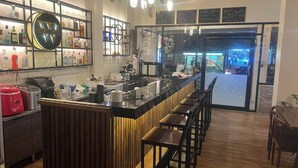 A bar area with a counter, stools, and a sign indicating free WiFi. - Butlers WDH (Bangkok)
