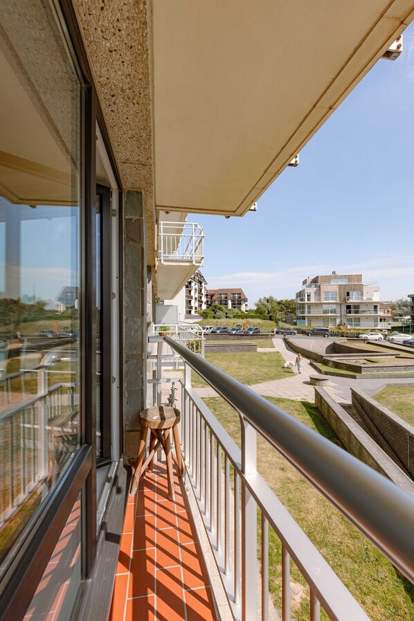 Enjoy a peaceful view of the surrounding neighborhood from this balcony.