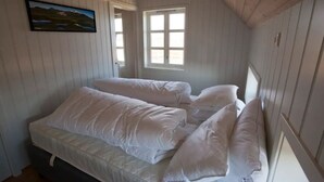 A room with a bed, a window, and a wall-mounted picture. - Day Dream Hellnar (Hellnar)