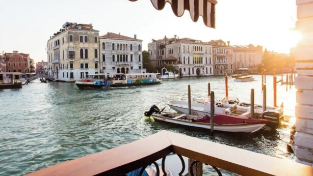 A canal with boats and historic buildings.