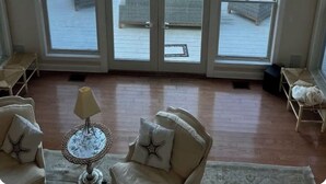 A room with a large bay window overlooking a pool and greenery. - Views ! Views! Views ! Water Front Property 
4 bedroom house  in Southampton  (Southampton)
