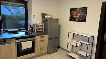 Fridge, stovetop, dishwasher, coffee/tea maker