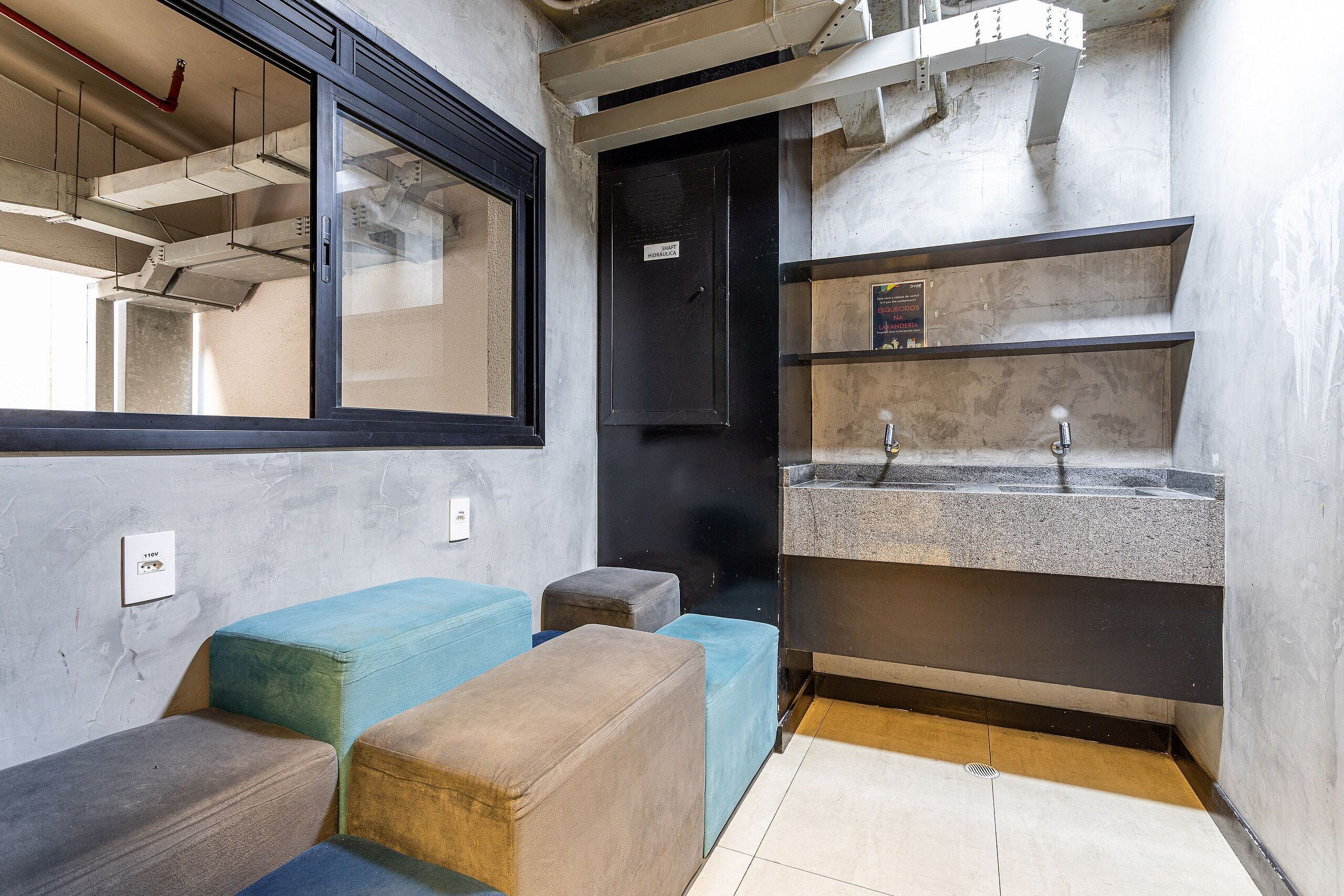 A room with a window, a sink, and a door.