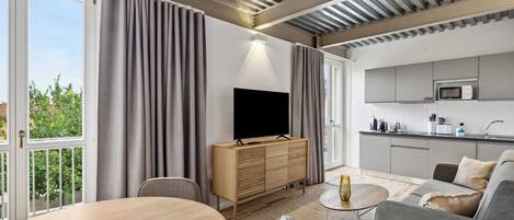 Apartment, 2 Bedrooms | Living area | 50-inch flat-screen TV with cable channels