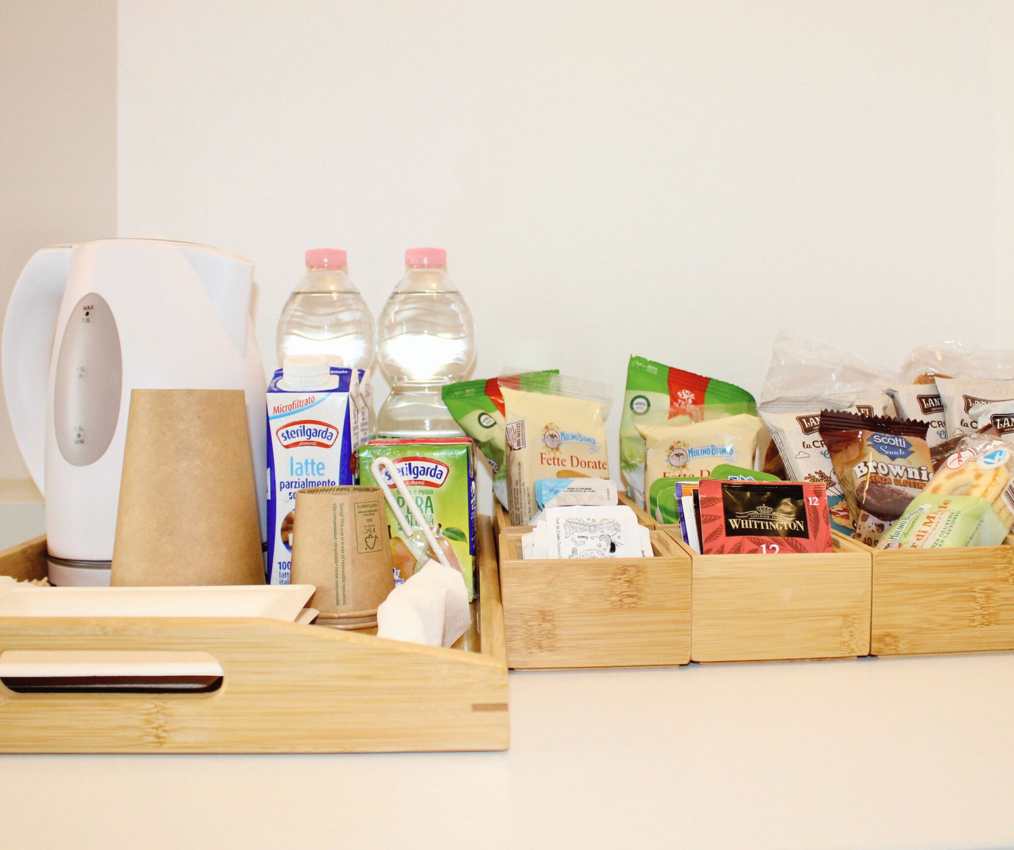A kitchen counter with various food items and kitchen appliances.