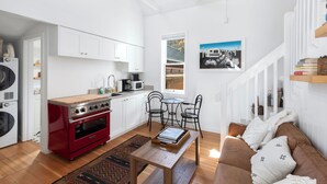 A compact living space with a kitchenette, a dining area, and a seating area. - Petite Maison: Hip & Historic (Telluride)