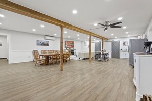 Enjoy meals at the large dining table surrounded by comfortable chairs, or relax in the seating area with a sofa and chairs.