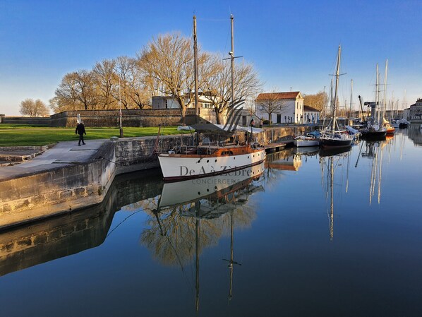 Enjoy serene harbor views with boats docked along the calm waters.