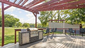 An outdoor deck with a grill, chairs, and a pergola. - Sleeps 10/Batting Cage/Theater! (Westfield)