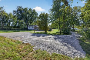 A residential driveway with a gravel surface leading to a house. - Sleeps 10/Batting Cage/Theater! (Westfield)