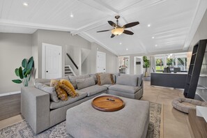 A spacious living room with a sectional sofa, a wooden coffee table, and a ceiling fan. - Sleeps 10/Batting Cage/Theater! (Westfield)