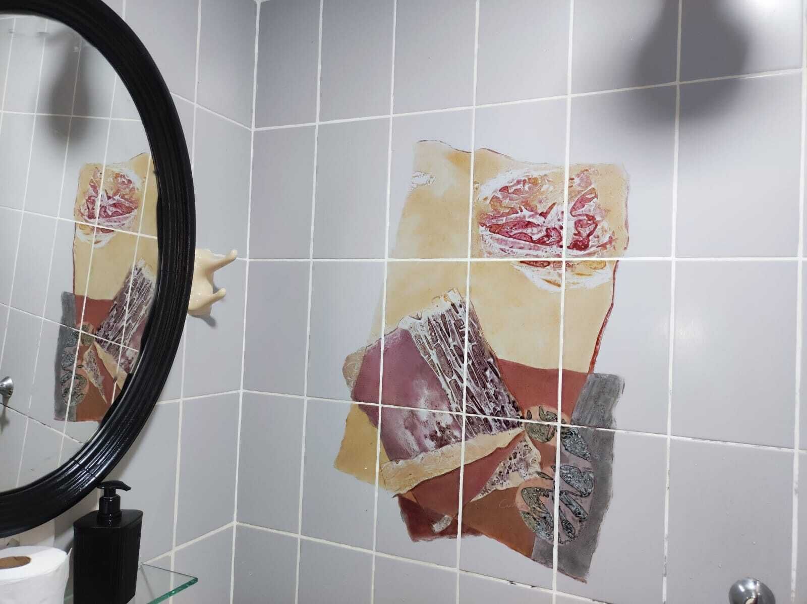 A bathroom with a mirror, a toilet, and a sink.