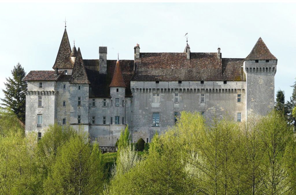 A large, historic stone castle with multiple towers and a fortified appearance.