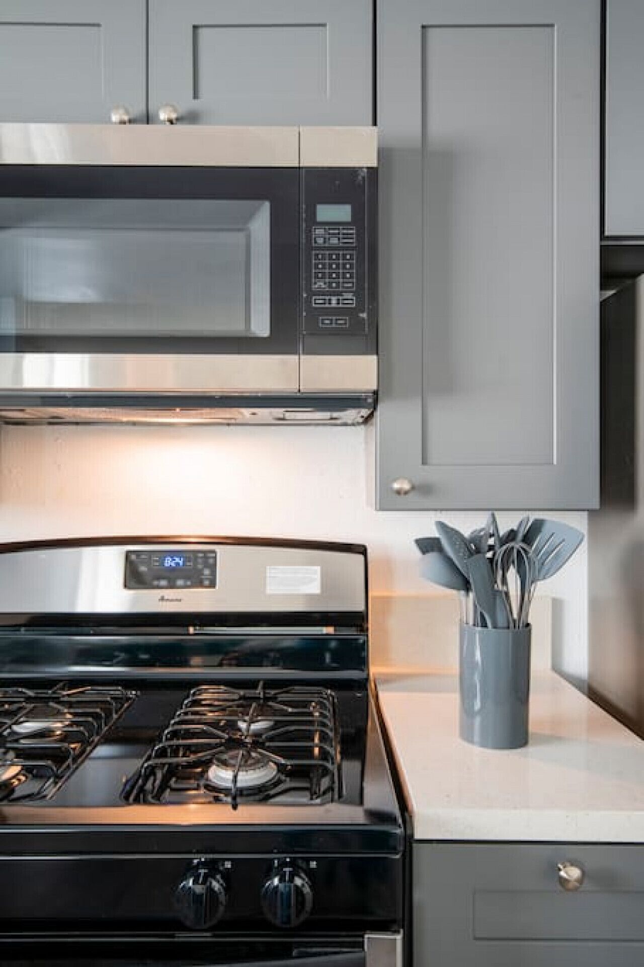 A kitchen with a stainless steel range hood, a built-in oven, and a gas stove.