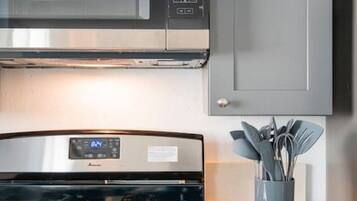A kitchen with a stainless steel range hood, a built-in oven, and a gas stove.