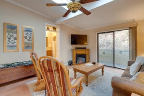 Cozy living room with a fireplace, television, and comfortable seating area.