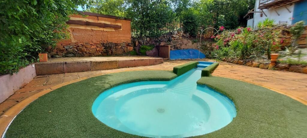 A circular pool with a green border and a central water feature.