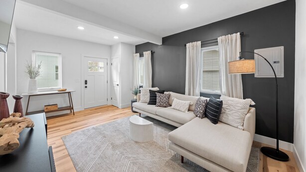 A modern living room with a sofa, a coffee table, and a floor lamp. - Charming 2-bedroom house in enchanting Cleveland with AC, WiFi  3219 (Cleveland)