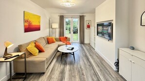 A modern living room with a sofa, coffee table, and TV.
