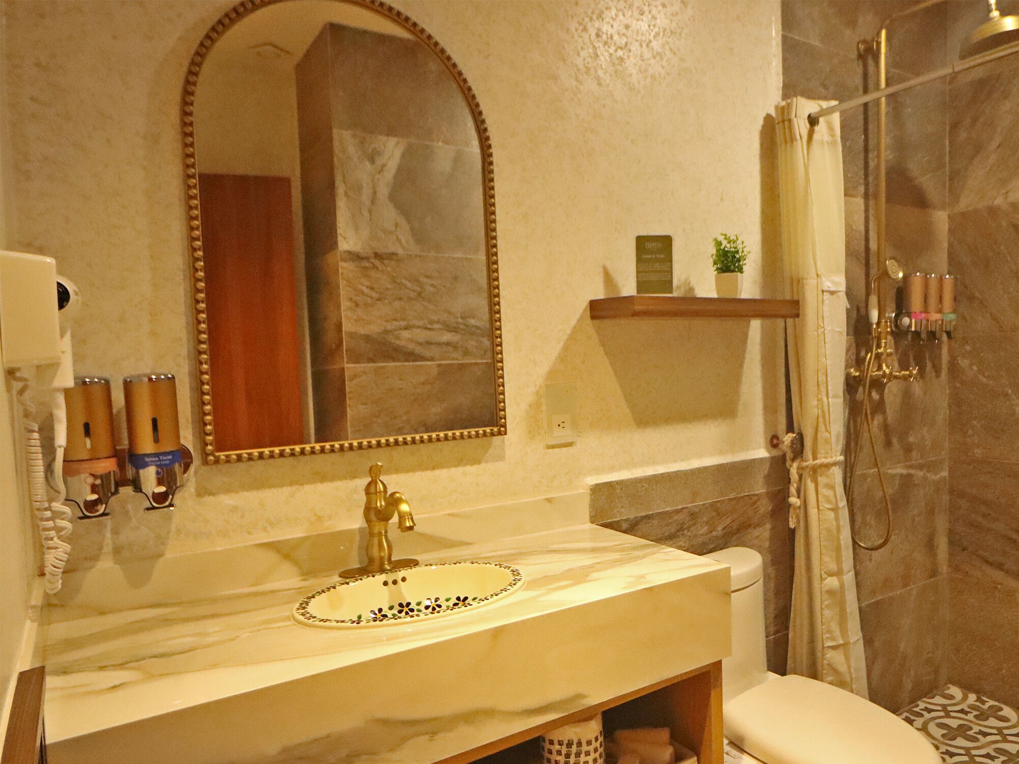 A bathroom with a marble sink, a large mirror, a shower with a glass door, and a towel rack.