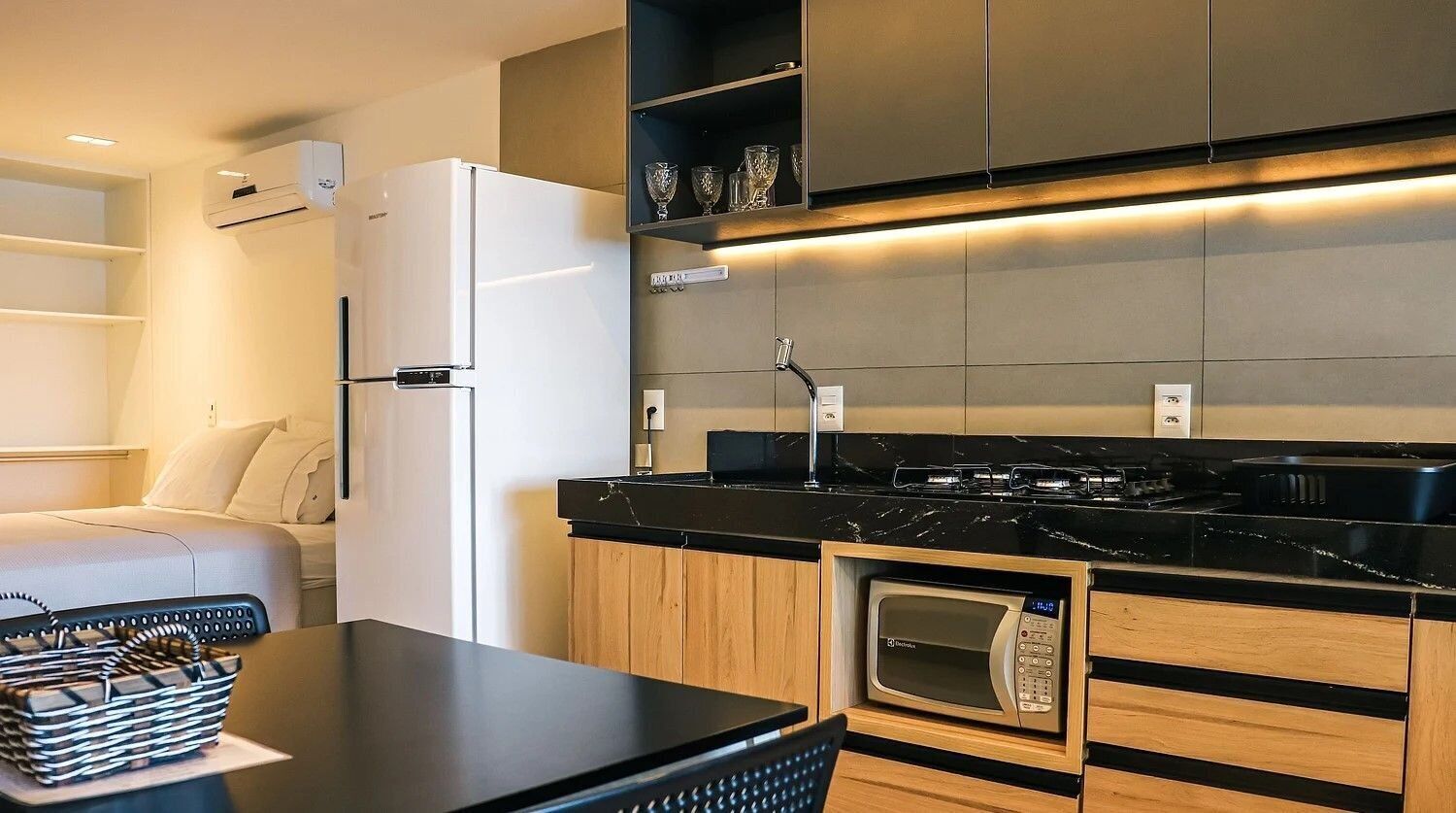 A modern kitchen with a built-in microwave, oven, and stove.