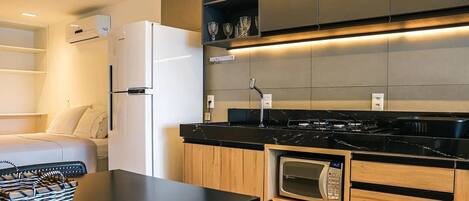 A modern kitchen with a built-in microwave, oven, and stove.