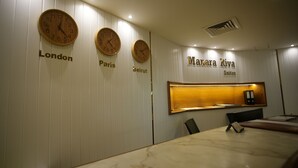 A hotel reception area with three clocks displaying times for London, Paris, and Beirut. The name 'Mahara Riva Suites' is visible above the reception desk. - Manara Riva Suites  (Beirut)