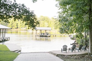 A lakeside dock with a covered seating area and chairs facing the water. - Lake Martin Waterfront, Private Boat Ramp, 30 Min to Auburn (Dadeville)