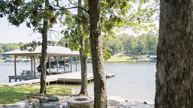 A lakeside gazebo with a picnic table and a stone fire pit. - Spacious, Private, Beautiful Lot in Holiday Shores (Dadeville)