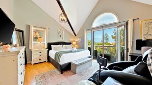 A bedroom with a bed, bedside tables, a desk, a chair, a window, and a balcony. - La Jolla Beach House. 2 Minute Walk to the Beach! (San Diego)