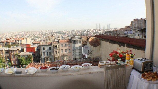 A balcony with a city view, a satellite dish, and various food items on the counter. - Dila Suites (Istanbul)