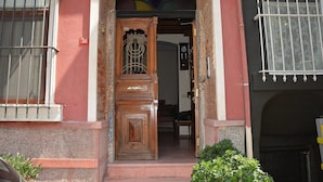 A wooden door with a metal grille, a number '16' sign, and a small window with bars. - Dila Suites (Istanbul)