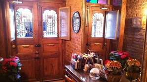 A wooden door with glass panels and a small window. - Dila Suites (Istanbul)