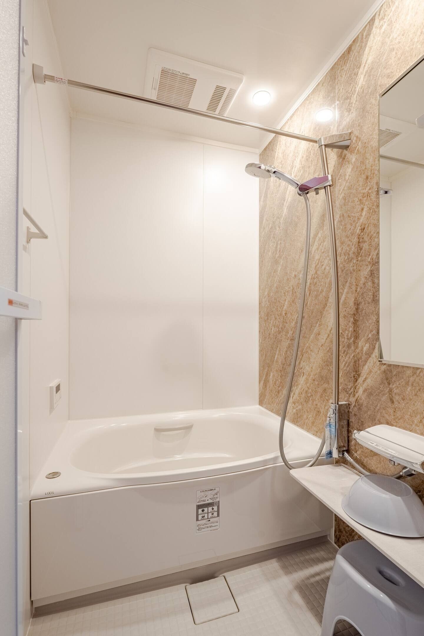 A modern bathroom with a bathtub, a shower, and a vanity with a mirror.