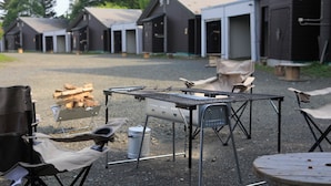 A row of cabins with outdoor seating and a grill area. - STARRY SKY COTTAGE 12 (Kitami)
