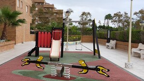 A playground with a seesaw, a slide, and a climbing structure. - ACV - Torremar-2ª Linea Planta 3 Sur (OROPESA)